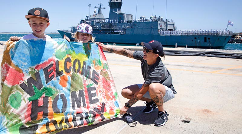 Blake, Shay and family friend Petty Officer Physical Training Instructor Tamara Prins wait for Petty Officer Combat Systems Supervisor Joseph Muckenthaler to arrive home as HMAS Anzac returns from deployment to Fleet Base West in Western Australia. Photo by Seaman Richard Edwards.