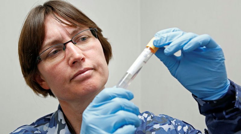 Air Force Specialist Reserve Forensic Doctor Flight Lieutenant Kirsty Wright with a sample for DNA testing. Story by John Noble. Photo by Corporal Colin Dadd.