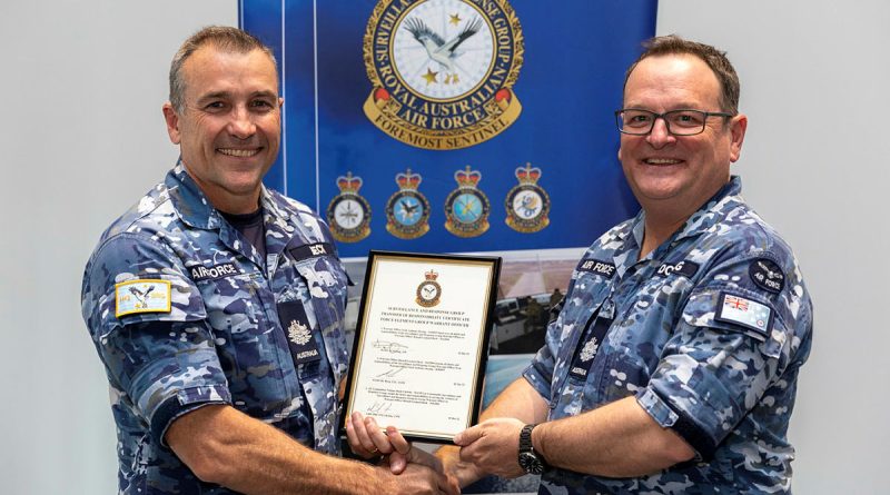 Surveillance and Response Group's Group Warrant Officer, Warrant Officer Scott Doring, right, hands over the reins to Warrant Officer Russell Beck during a ceremony at RAAF Base Williamtown. Story by Flight Lieutenant Claire Burnet. Photo by Leading Aircraftman Samuel Miller.