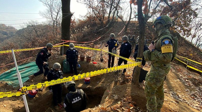 Australian observer Leading Aircraftman Ben Whitfield, right, observes personnel from the Ministry of National Defense for Killed in Action Recovery and Identification conduct human remains recovery at White Horse Hill. Story and photo by Petty Officer Jason Wilson.