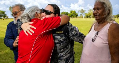 Leading Seaman Teneille Francis is welcomed home by members of her family during a community day at Fitzroy Crossing, Western Australia. Story byLieutenant Geoff Long. Photo by Sergeant David Said.