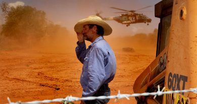 Jack Andrews, Station Manager at Yeeda Station, shelters from the dust as an MRH-90 Taipan delivers animal feed. Photos by Leading Aircraftwoman Kate Czerny. Story by Flight Lieutenant Dean Squire.