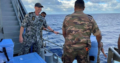 Chief Petty Officer Garry Danaher with a member of the Royal Tongan Navy on board an Australian-gifted Guardian-class patrol boat in Tonga. Story byCorporal Jacob Joseph.
