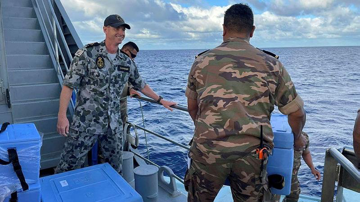Chief Petty Officer Garry Danaher with a member of the Royal Tongan Navy on board an Australian-gifted Guardian-class patrol boat in Tonga. Story byCorporal Jacob Joseph.