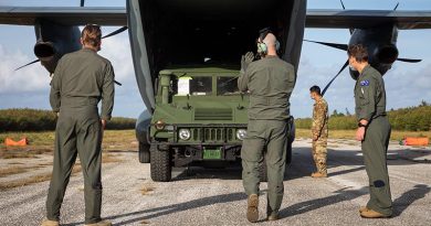 Royal Australian Air Force loadmaster Corporal Daniel Smith (centre) guides a United States Air Force Humvee out of a C-27J Spartan from No. 35 Squadron on Tinian island, Northern Mariana Islands, during Exercise Cope North 2022. Photo by Leading Aircraftman Sam Price.