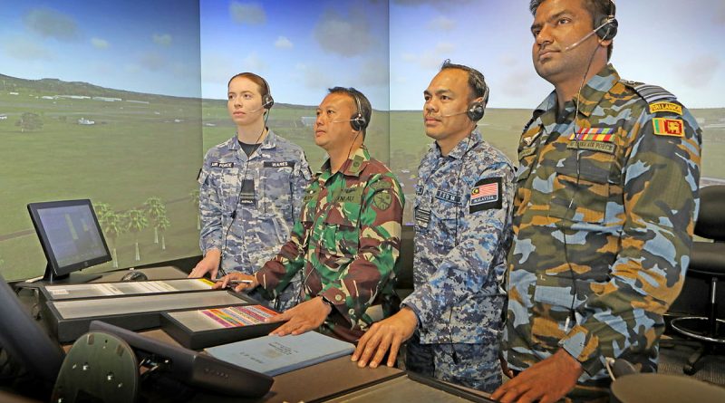 Flight Lieutenant Rhiannon Wares (RAAF), First Lieutenant Hery (Indonesia Air Force), Major Hafizul (Royal Malaysian Air Force) and Squadron Leader Chamara (Sri Lanka Air Force) in the School of Air Traffic Control’s immersive tower visual simulator system at RAAF Base East Sale. Story by Flying Officer Rowan Crinall. Photo by Petty Officer Richard Prideaux.