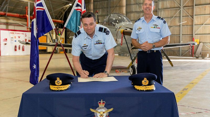 Incoming Commander Air Warfare Centre Air Commodore Adrian Maso, signs the transfer of command certificate witnessed by the outgoing Commander Air Commodore Ross Bender. Story by Flight Lieutenant Rob Hodgson. Photo by Corporal David Cotton.