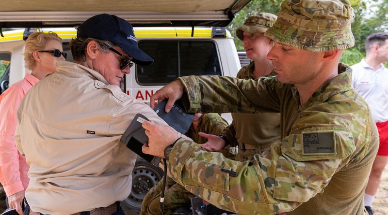 Australian Army soldier Private Thomas Marshall, right, from the 3rd Health Battalion, fits a blood pressure cuff to Megan Stifler, Deputy Commissioner Strategic Capability, Fire and Rescue NSW. Photo by Corporal Michael Currie.