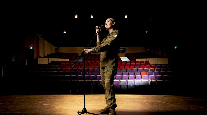 Squadron Leader Aleisha Croxford on stage at the Gungahlin College Theatre in Canberra. Story and photo by Private Nicholas Marquis.