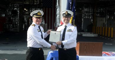 Washington Naval Attaché Commodore Darren Grogan, left, congratulates Warrant Officer Luke Brewer on his promotion on board USS Canberra. Story by Lieutenant Commander Steven Witzand. Photo by Mass Communication Specialist Second Class Vance Ha (US Navy).