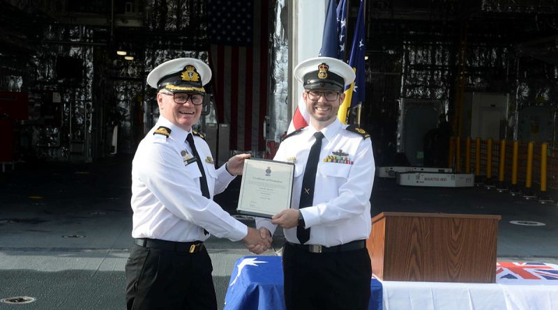 Washington Naval Attaché Commodore Darren Grogan, left, congratulates Warrant Officer Luke Brewer on his promotion on board USS Canberra. Story by Lieutenant Commander Steven Witzand. Photo by Mass Communication Specialist Second Class Vance Ha (US Navy).