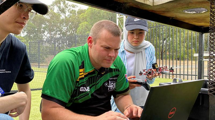 Sapper Alex Brown helps Year 10 student Adiba to code her drone at RMIT’s Girls in Aerospace and Defence program in Bundoora.