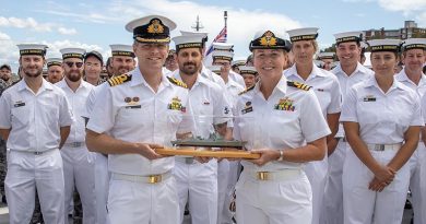 Outgoing Commanding Officer Commander Andrew Pepper exchanges the 'weight of command' of DDG39 to new Commanding Officer Commander Tina Brown. Photo by Petty Officer Christopher Szumlanski.