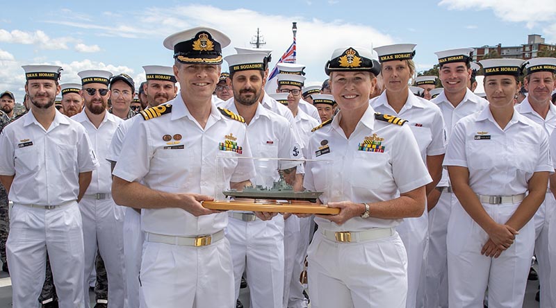 Outgoing Commanding Officer Commander Andrew Pepper exchanges the 'weight of command' of DDG39 to new Commanding Officer Commander Tina Brown. Photo by Petty Officer Christopher Szumlanski.