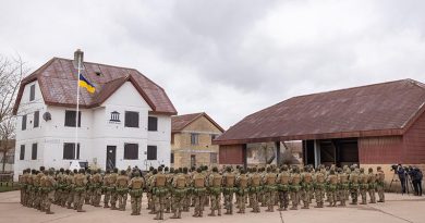 Ukrainian recruits gather to commemorate the year anniversary of the full-scale Russian invasion of Ukraine at a urban training facility in the United Kingdom. Image has been altered for security purposes. Photo by Corporal Jonathan Goedhart.