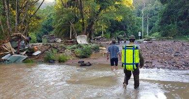 Soldiers and locals wade through the 2022 flood waters in Lismore, checking properties for stranded residents. Story by Private Nicholas Marquis.