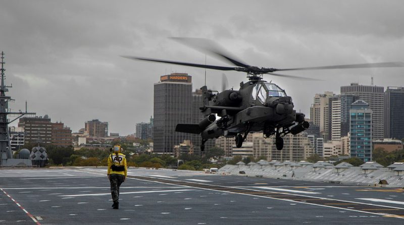 Leading Seaman Avation Support Alyssa Clark marshalls a US Army AH-64E Apache on the deck of HMAS Canberra while the ship is alongside at Fleet Base East in Sydney. Story and photos by Petty Officer Helen Frank.