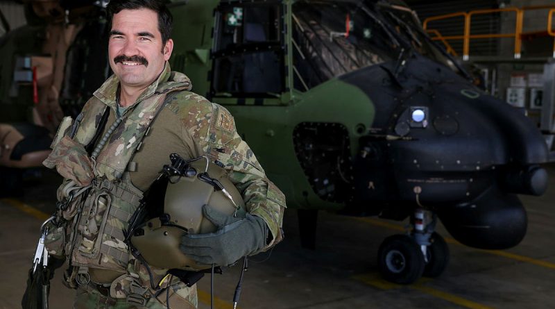 Aircrewman Sergeant Damien Collison-Bryant stands in front of an MRH-90 Taipan at the Australian Army Aviation Training Centre, Swartz Barracks, Queensland. Story by Carolyn Barnett. Photo by Brad Richardson.