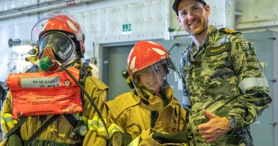 Lieutenant Commander Luke Marconi of HMAS Canberra shows damage control equipment to members of the public at HMAS Kuttabul's Open Day during Navy Week. Private Nicholas Marquis. Photos by Able Seaman Benjamin Ricketts.