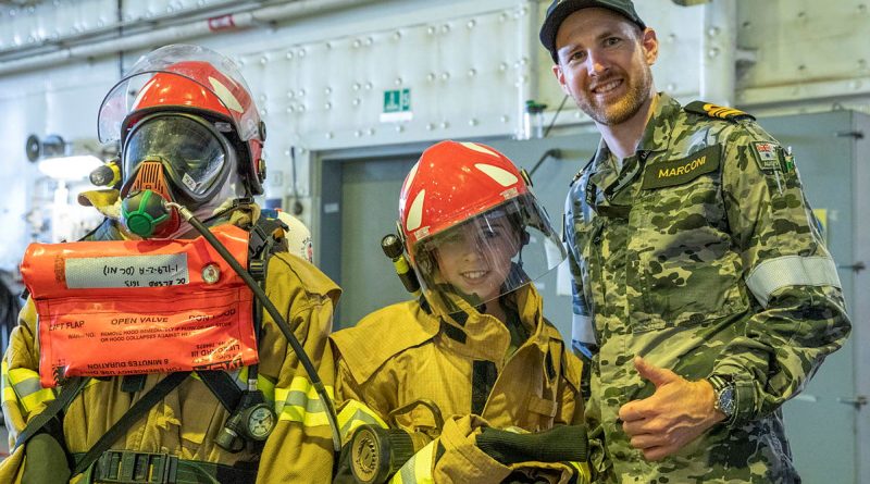 Lieutenant Commander Luke Marconi of HMAS Canberra shows damage control equipment to members of the public at HMAS Kuttabul's Open Day during Navy Week. Private Nicholas Marquis. Photos by Able Seaman Benjamin Ricketts.