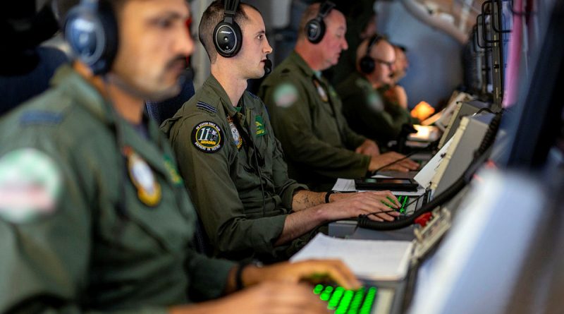 RAAF Tactical Coordinator Flight Lieutenant Brad Jolly, centre, at his station on-board a P-8A Poseidon during Operation Argos 2023. Story by Flying Officer Connor Bellhouse. Photo by Sergeant Nicci Freeman.