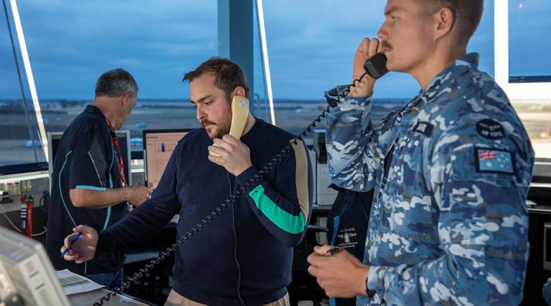 Flight Lieutenant Maxim David, from 453 Squadron, and Michael Mihalic, from Airservices Australia, at work in the air traffic control tower at the Australian International Airshow 2023. Story by By Flying Officer Shan Arachchi Galappatthy. Photo by LAC Chris Tsakisiris.