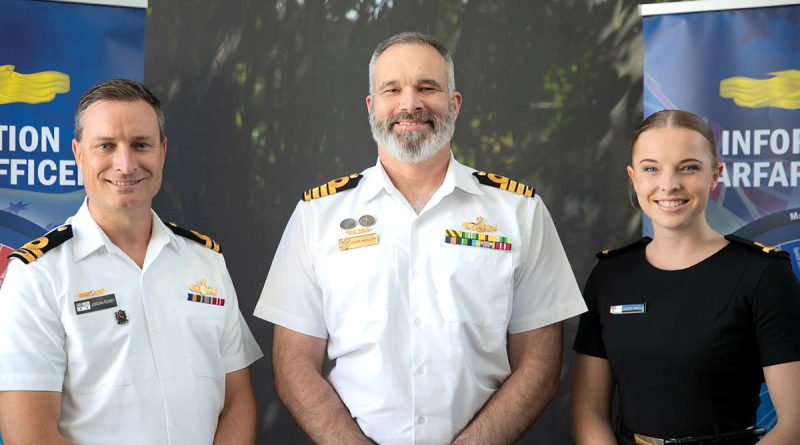 From left, information warfare officers Lieutenant Jordan Roney, Captain Andrew Macalister and Sub-Lieutenant Jacqui Meacle celebrate the work group’s first anniversary as a primary qualification. Story and photo by Corporal Michael Rogers.
