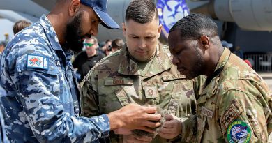 Royal Australian Air Force Indigenous Liaison Officer, Flight Lieutenant Micheal Naawi promotes cultural awareness to Master Sergeant Jonathan Cowan (middle) and Master Sergeant Marcello Lindo of the United States Air Force during the Australian International Airshow 2023 at Avalon. Story by Flying Officer Shan Arachchi Galappatthy. Photo: Leading Aircraftwoman Kate Czerny.