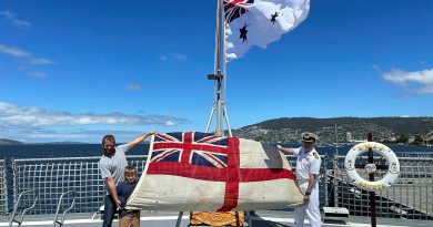 Duncan and Hudson Mennitz present the ensign from HMAS Arunta I to Commanding Officer HMAS Arunta II Commander Jason McBain. Story and photo by Sub-Lieutenant Tahlia Merigan.
