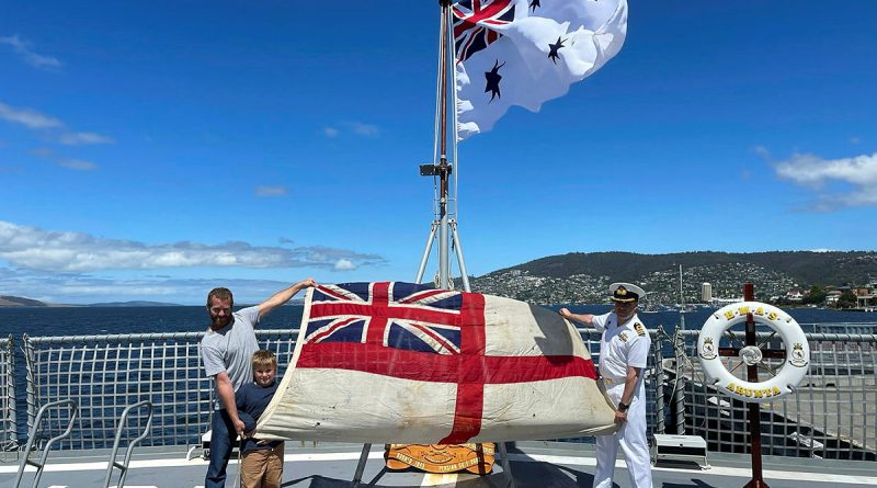 Duncan and Hudson Mennitz present the ensign from HMAS Arunta I to Commanding Officer HMAS Arunta II Commander Jason McBain. Story and photo by Sub-Lieutenant Tahlia Merigan.