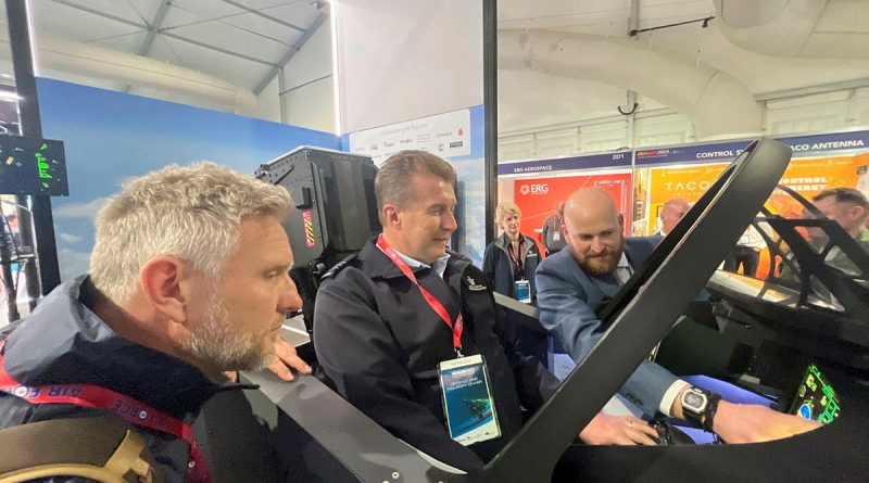 News presenter and Air Force Reservist Wing Commander Peter Overton, centre, with Simon Hobbs, left, testing a flight simulator at Avalon Air Show. Photo by Alex Given.