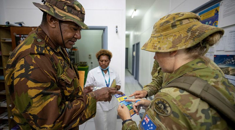 Australian Army medic Sergeant Kathleen Cole speaks with Papua New Guinea Defence Force Warrant Officer Class 2 Jerry Aini at Murray Barracks Health Centre, Port Moresby. Story Captain Joanne Leca. Photo by Corporal Brandon Grey.