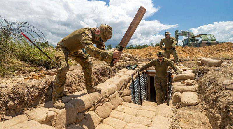 Sapper Dean Ridgeway tamps sandbags during a trench construction activity in Townsville. Story by Major Taylor Lynch. Photos by Sergeant Brodie Cross.