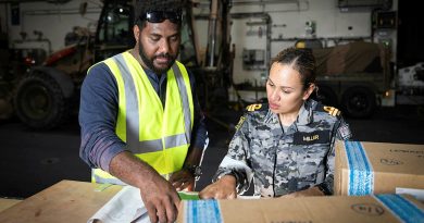 Greg Willie, co-leader of logistics and procurement under the National Health Emergency Operation Committee, and Lieutenant Donna Miller organise goods and cargo on board HMAS Canberra in support of Operation Vanuatu Assist. Story by Lieutenant Geoff Long. Photo by Leading Seaman Matthew Lyall.