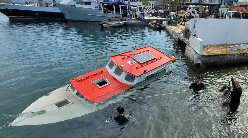 Members of Australian Clearance Diving Team One conduct a salvage diving operation in Port Vila Harbour during Operation Vanuatu Assist. Story by Lieutenant Geoff Long. Photo by Able Seaman Michaela Bennett.