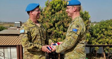 Outgoing Commander of the Australian Contingent, Colonel Richard Watson, left, hands over command to Colonel David Hughes on February 18. Photo by Flight Lieutenant Aminta Thomas.