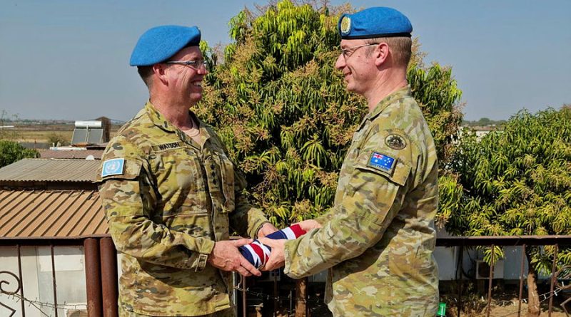 Outgoing Commander of the Australian Contingent, Colonel Richard Watson, left, hands over command to Colonel David Hughes on February 18. Photo by Flight Lieutenant Aminta Thomas.
