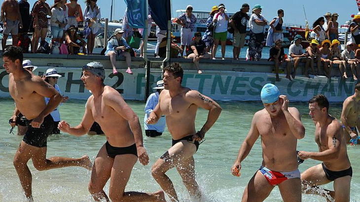 Soldiers and officers from 16th Battalion, The Royal Western Australia Regiment, and 10th Light Horse Regiment run to shore during the Rottnest Channel Swim. Story by Major Sandra Seman-Bourke. Photo by Lieutenant Colonel Lachlan Bromley.