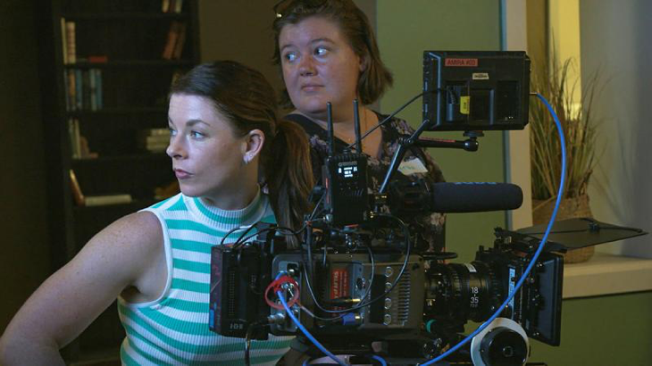 Lieutenant Commander Claire Baldwin, left, from the Directorate Navy Culture, takes control of the camera during the Screen Warriors training program. Story by Corporal Michael Rogers.