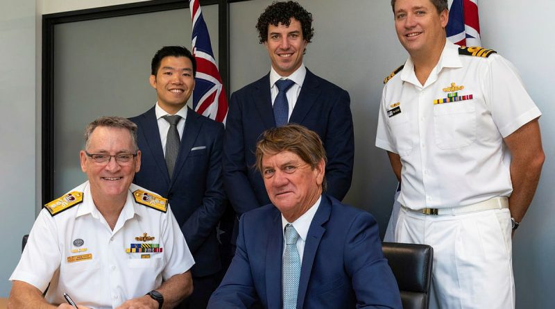 Rear Admiral Steven Tiffen, front left, signs a contract with Noakes Group Managing Director Sean Langman, front right, with members from Mine Warfare and Clearance Diving Systems Program Office and Noakes Group. Story by Phillip Morton. Photo by Able Seaman Benjamin Ricketts.