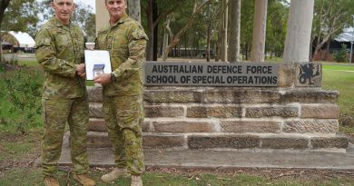 Major General Paul Kenny, left, Special Operations Commander for Australia, presents Major Paul Dunbavin from the Australian Defence Force School of Special Operations with his Chief of Army gold commendation at Holsworthy Barracks, Sydney.