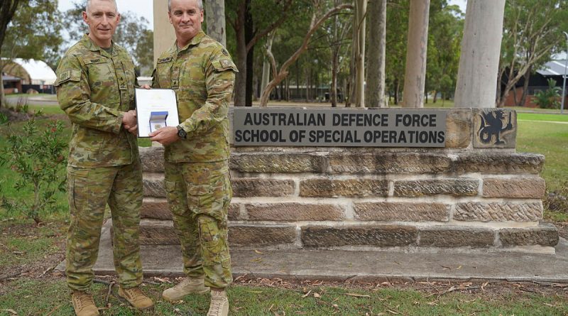 Major General Paul Kenny, left, Special Operations Commander for Australia, presents Major Paul Dunbavin from the Australian Defence Force School of Special Operations with his Chief of Army gold commendation at Holsworthy Barracks, Sydney.
