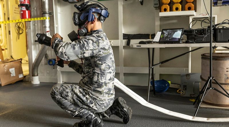 Able Seaman Kevin Tran uses the virtual reality damage control system on board HMAS Brisbane at Fleet Base East, Sydney. Story by Meg Van Lohuizen. Photo by Able Seaman Allanson.