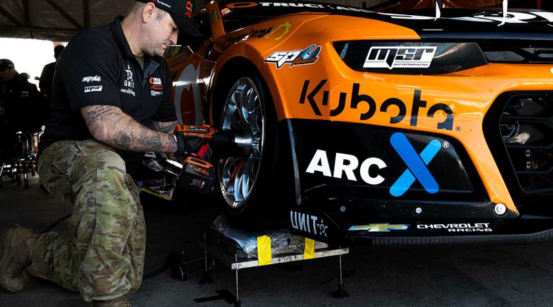Warrant Officer Class Two Luke Parlor, a mechanic from Defence Force School of Signals conducts maintenance on a V8 Supercar at the Australian Formula 1 Grand Prix in Melbourne. Story by Flight Lieutenant Marina Power. Photo by Leading Aircraftwoman Taylor Anderson.