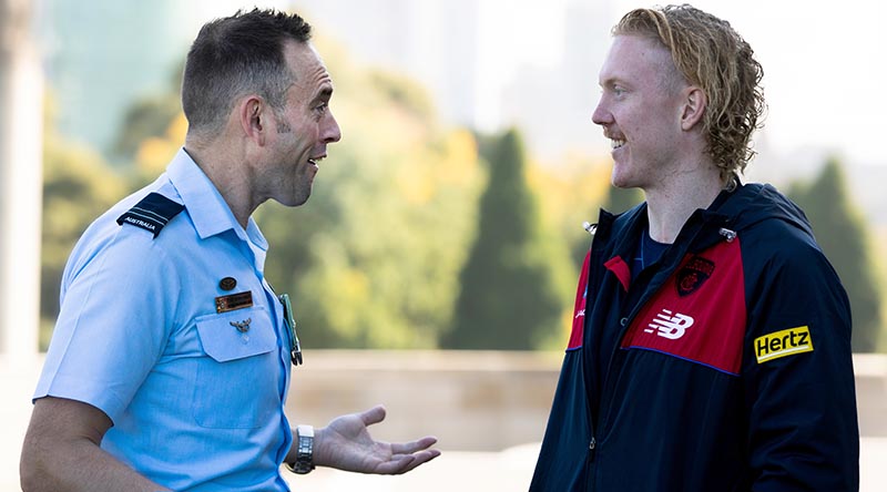 Flight Lieutenant Adon Lumley chats with Clayton Oliver from the Melbourne Football Club on ANZAC Day at The Shrine of Remembrance, Melbourne. Photo by Leading Aircraftman Ryan Howell.