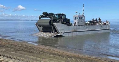 The CAT938K with Faun Trackway on the front drives off a landingcraft on to Lomolomo Beach, Fiji. NZDF photo.