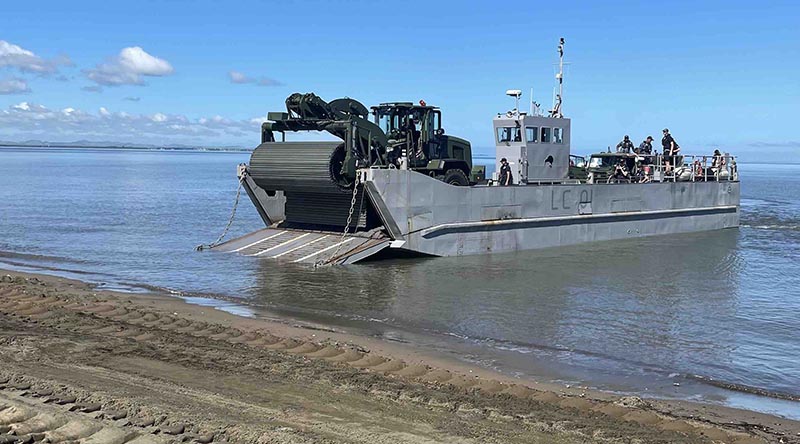 The CAT938K with Faun Trackway on the front drives off a landingcraft on to Lomolomo Beach, Fiji. NZDF photo.