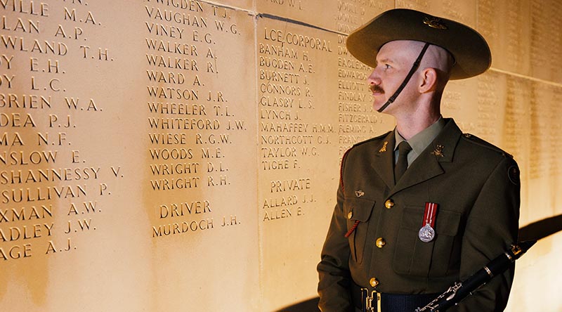 Musician Scott Collinson, from the Australian Army Band, stands beside the name of his relative, Private Alexander Walker, before the Anzac Day Dawn Service at the Australian National Memorial in Villers-Bretonneux, France. Photo by Sergeant Oliver Carter.