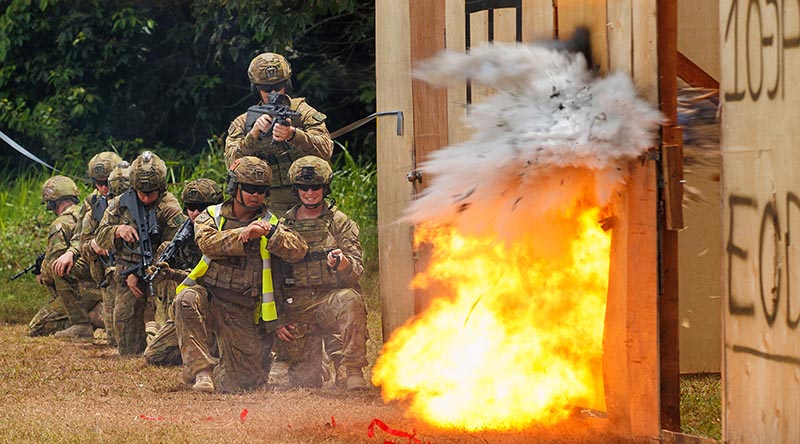 Australian soldiers use an explosive breaching charge to blow open a doorway at the Baturaja Training Area in Indonesia during Exercise Wirra Jaya. Photo by Corporal Dustin Anderson.