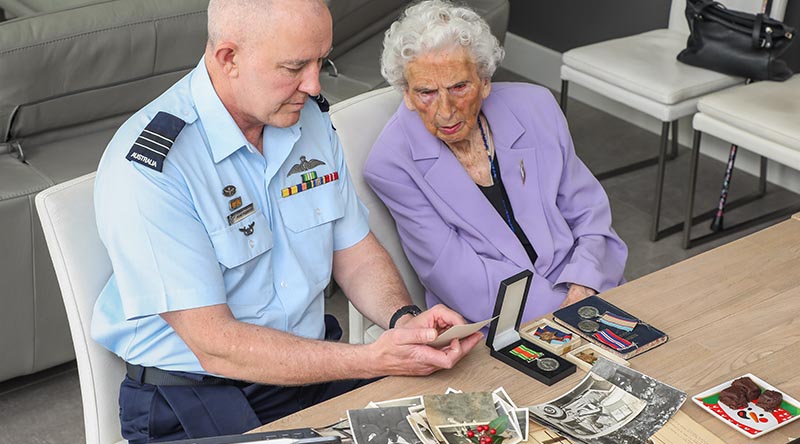 Wing Commander Adam Robinson reminisces with 100-year-old Dorothy Craig about her spouse, WWII RAAF veteran Lloyd Craig, who died in 1962. Photo by Corporal Brenton Kwaterski.